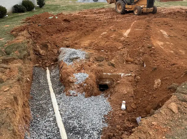 Septic line and gravel bed exposed during a King and Sons repair